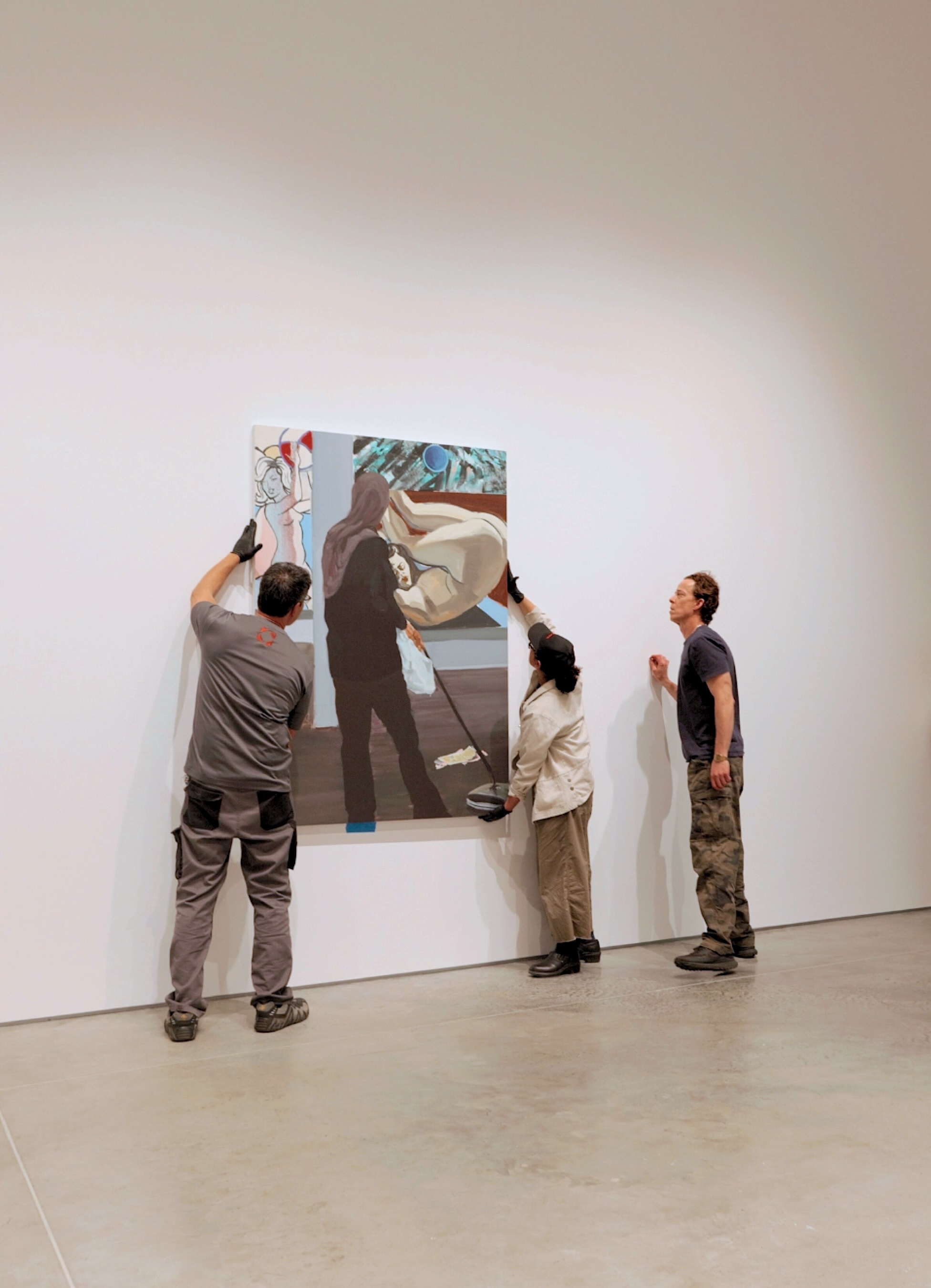 Crozier handlers installing painting on the wall