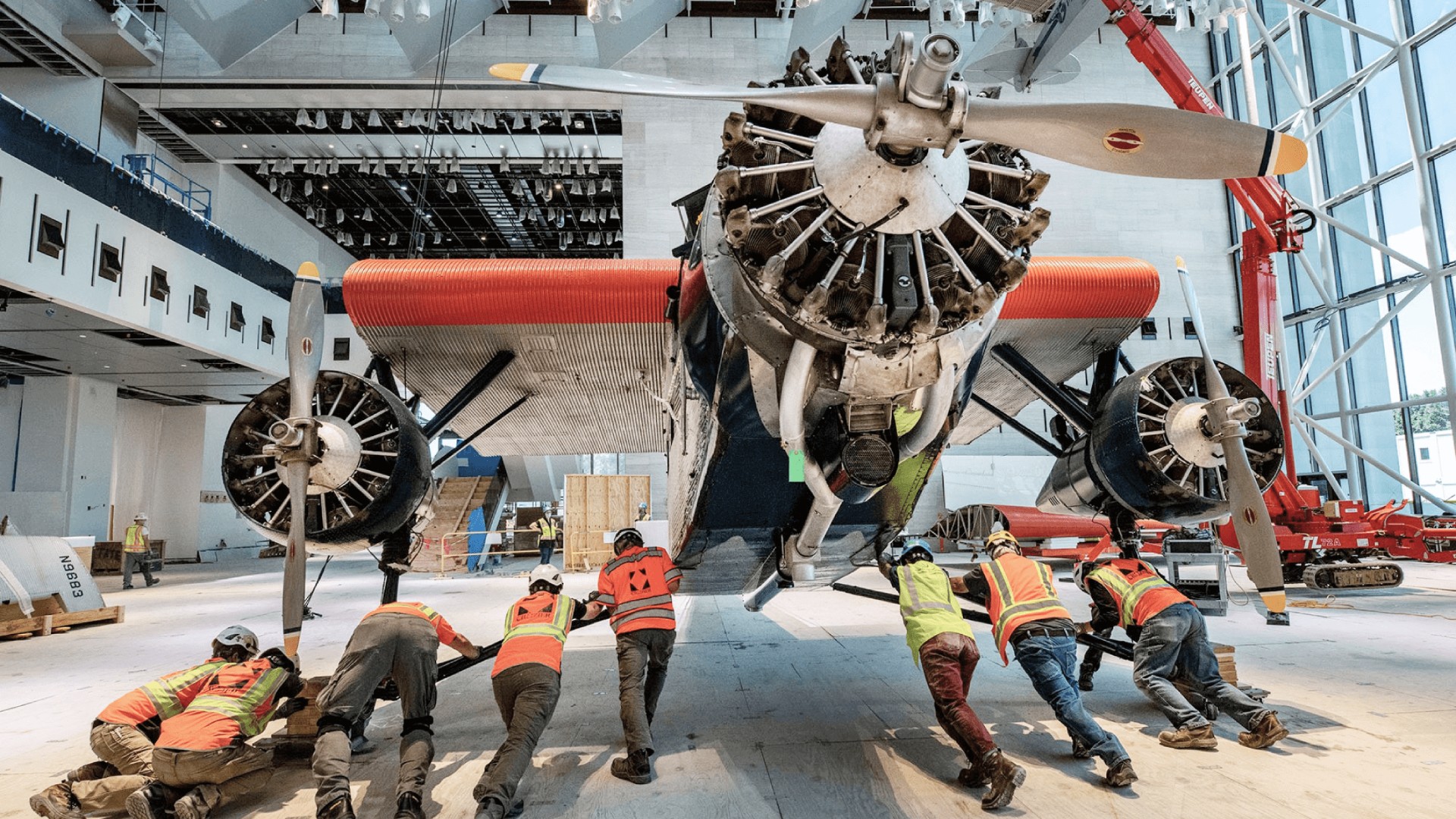 Crozier team members navigate the "Tin Goose," a 1928 Ford 5-AT Tri-Motor into place in the "America by Air" gallery. Photo courtesy of Jim Preston / The Washingtonian.
