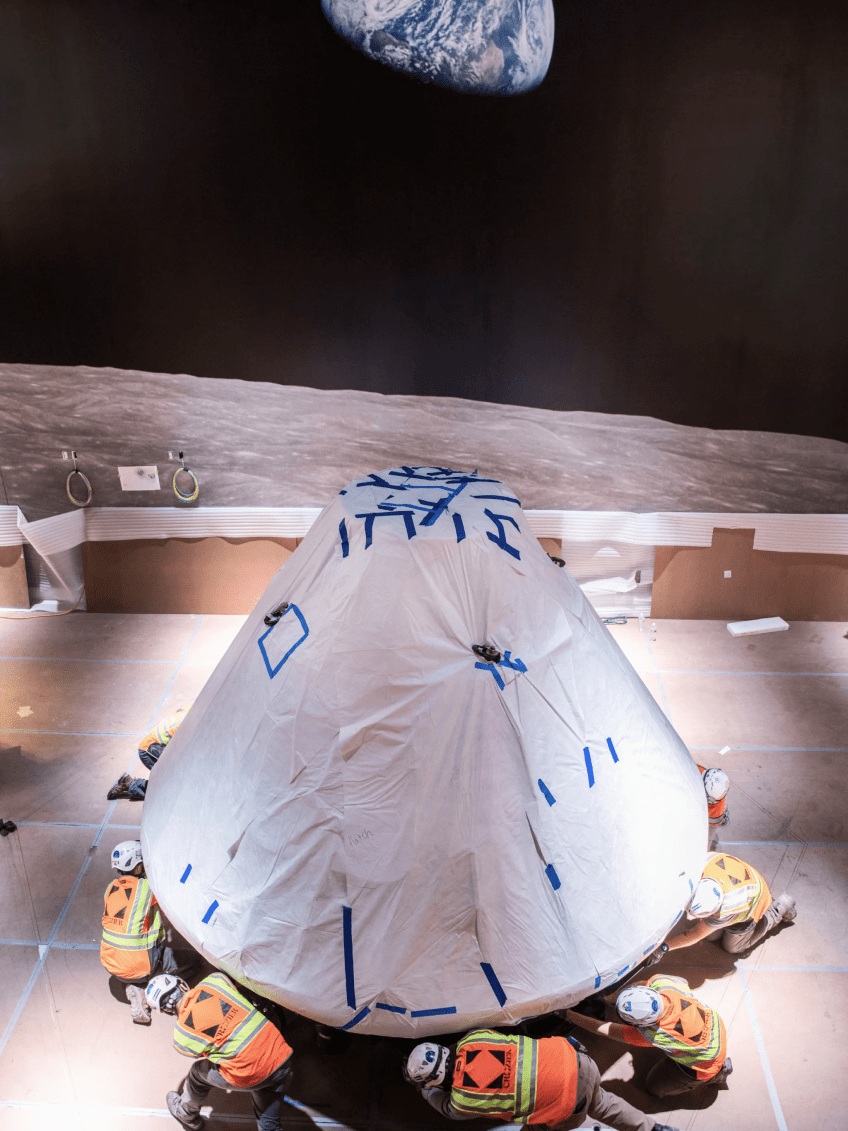 Crozier technicians get ready to mount the Apollo 11 command module, called Columbia, in the "Destination Moon" gallery. Photo courtesy of Jim Preston / The Washingtonian.